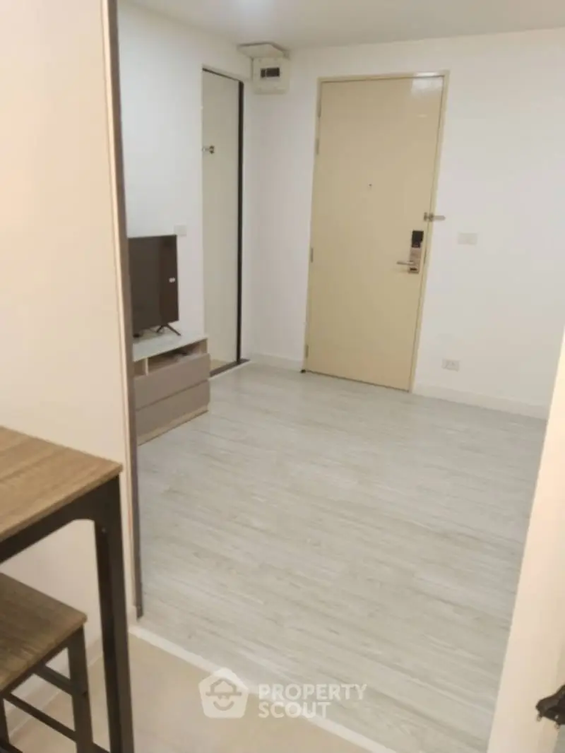 Modern apartment entrance with sleek flooring and minimalist design