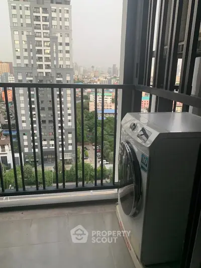 High-rise balcony with city view and washing machine, perfect for urban living.