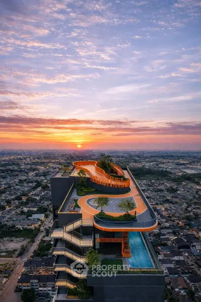 Stunning rooftop view of modern building with pool and sunset backdrop