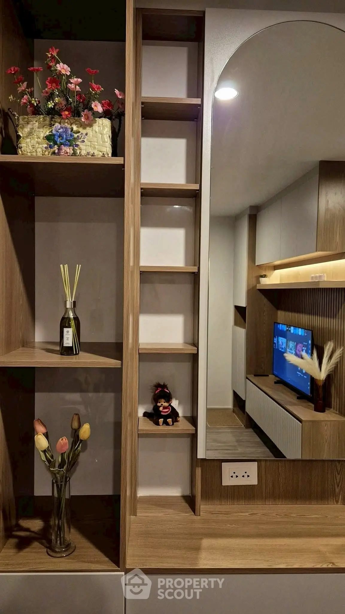 Modern living room with stylish wooden shelving and decorative accents