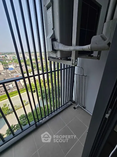 Modern balcony with city view and air conditioning unit, perfect for urban living.