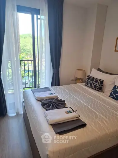 Bright and cozy bedroom with balcony view in modern apartment