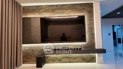 Modern living room with sleek TV setup and ambient lighting