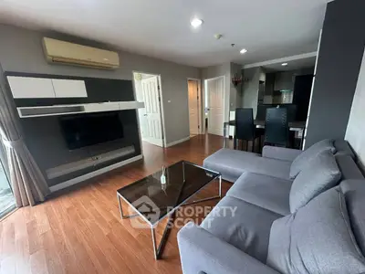 Modern living room with sleek furniture and wooden flooring in a stylish apartment.