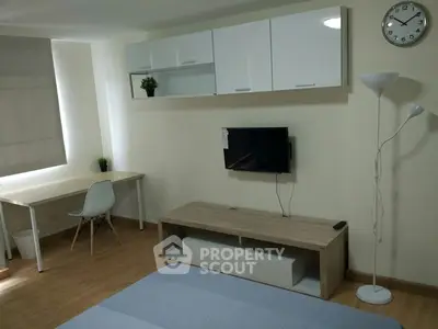 Modern minimalist living room with wall-mounted TV and sleek furniture