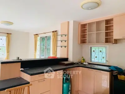 Spacious kitchen with open layout and modern cabinetry in a bright home