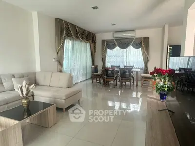Spacious living room with elegant curtains and modern furniture, perfect for family gatherings.