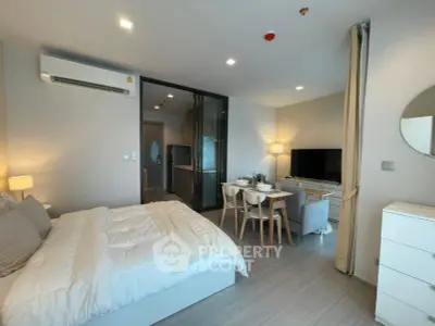 Modern studio apartment with cozy bedroom and open kitchen layout