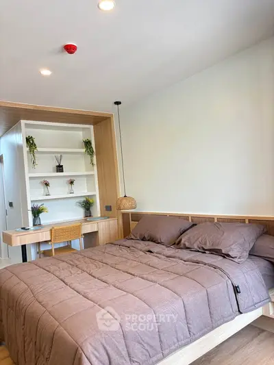 Modern bedroom with stylish wooden furniture and cozy bedding in a bright apartment.