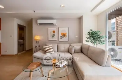 Modern living room with stylish decor and large windows for natural light.