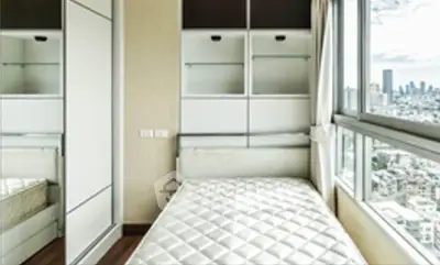 Modern bedroom with city view and built-in storage