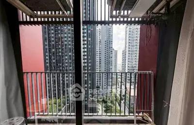 Stunning urban balcony view with high-rise buildings and cityscape.