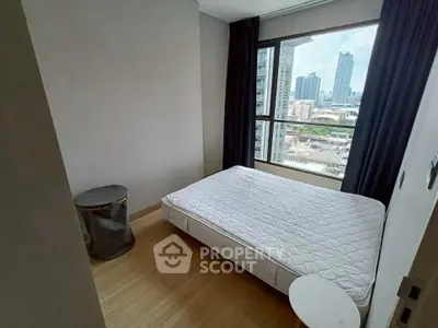 Modern bedroom with city view, featuring a large window and minimalist decor.