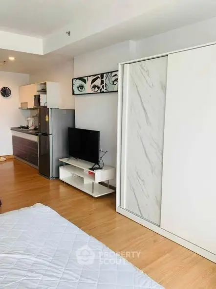 Modern studio apartment with sleek kitchen and stylish decor