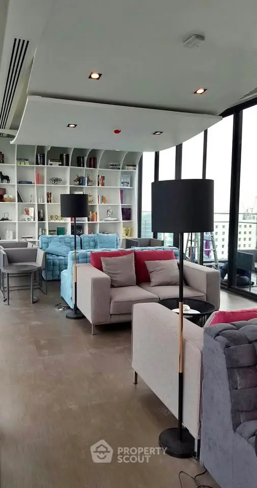 Modern living room with floor-to-ceiling windows and stylish furniture