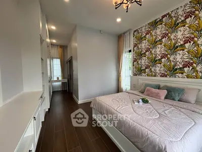 Elegant bedroom with floral accent wall and cozy bedding in modern home