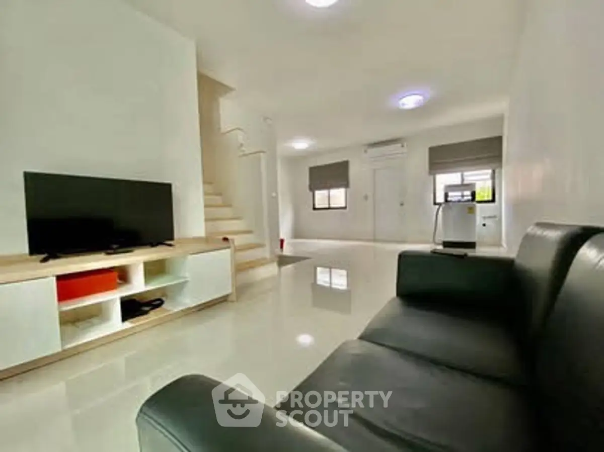 Spacious modern living room with sleek furniture and natural light