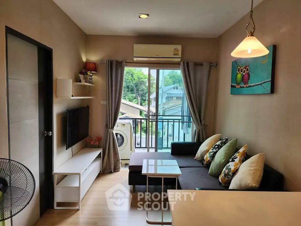 Cozy living room with balcony view, modern decor, and natural light