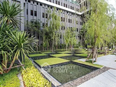 Modern building exterior with landscaped garden and water features