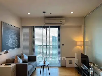 Modern living room with city view, cozy sofa, and stylish decor.