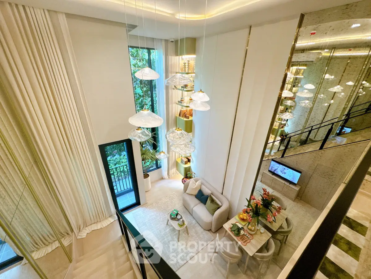 Luxurious modern living room with high ceilings and elegant lighting in a stylish apartment.