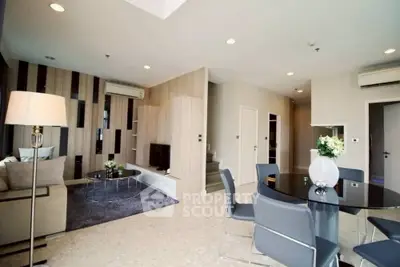 Modern living room with stylish decor and open dining area