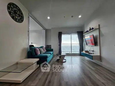 Modern living room with stylish decor and balcony view