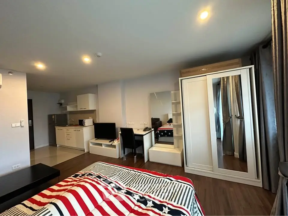 Modern studio apartment with stylish decor and open kitchen layout