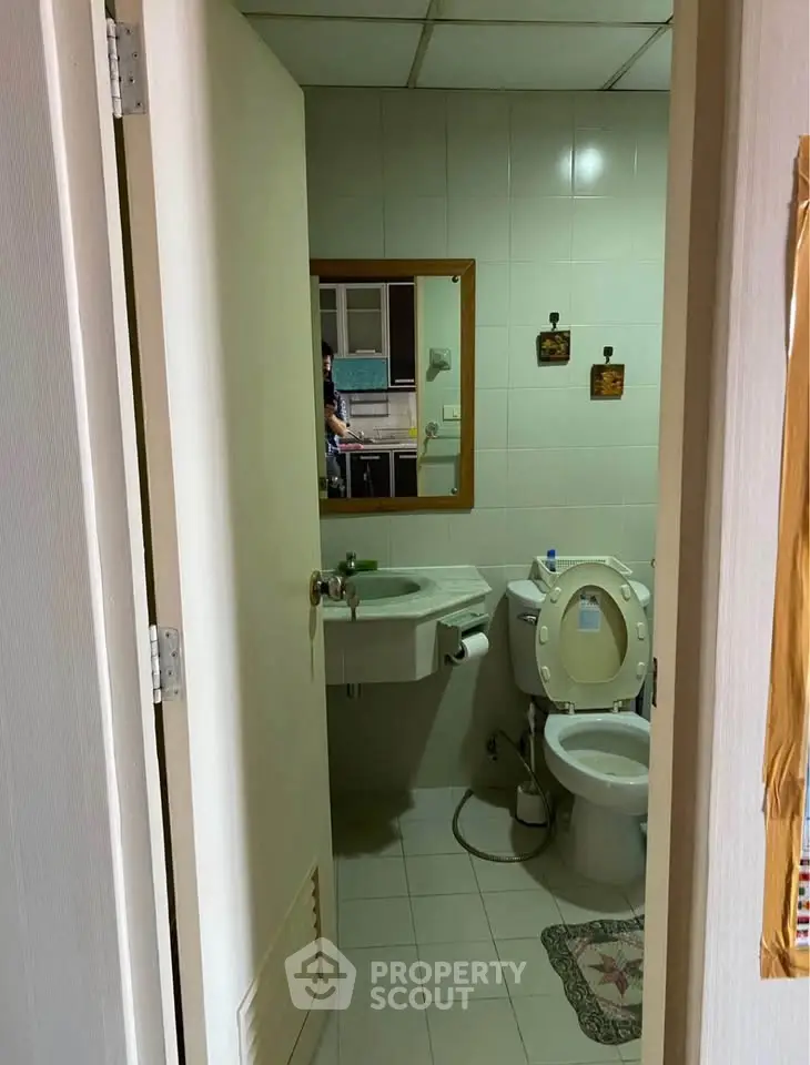 Cozy bathroom with modern fixtures and tiled walls, perfect for a compact living space.