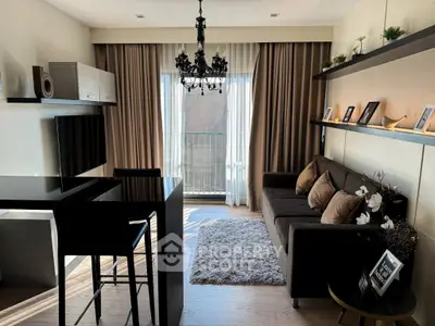 Stylish modern living room with elegant chandelier and cozy sofa, perfect for urban living.