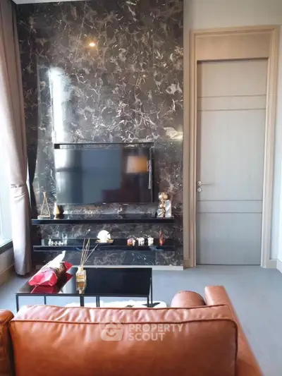 Luxurious living room with marble accent wall and modern TV setup
