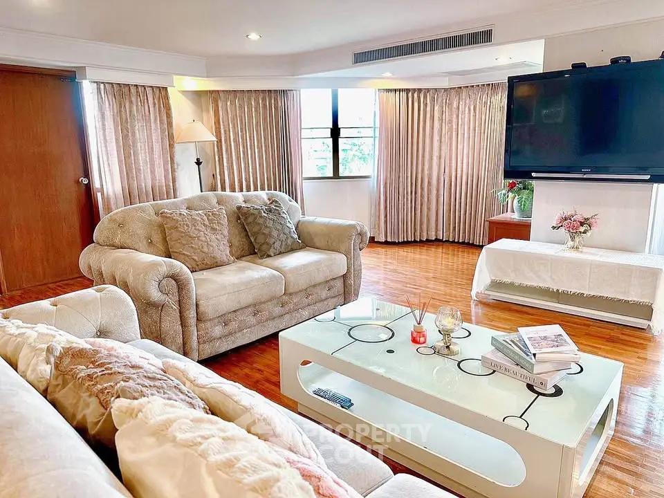 Spacious living room with elegant decor and large windows, perfect for relaxation and entertainment.