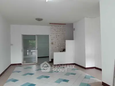 Spacious living room with unique tile flooring and sliding glass doors