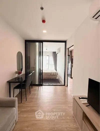 Modern apartment interior with open layout, featuring a cozy living area and stylish bedroom.