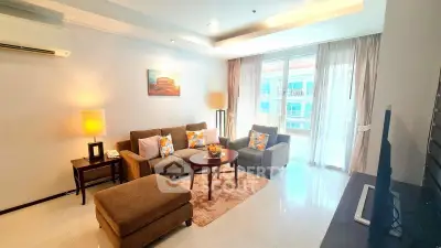 Spacious living room with modern decor and natural light, featuring a cozy seating area and elegant furnishings.