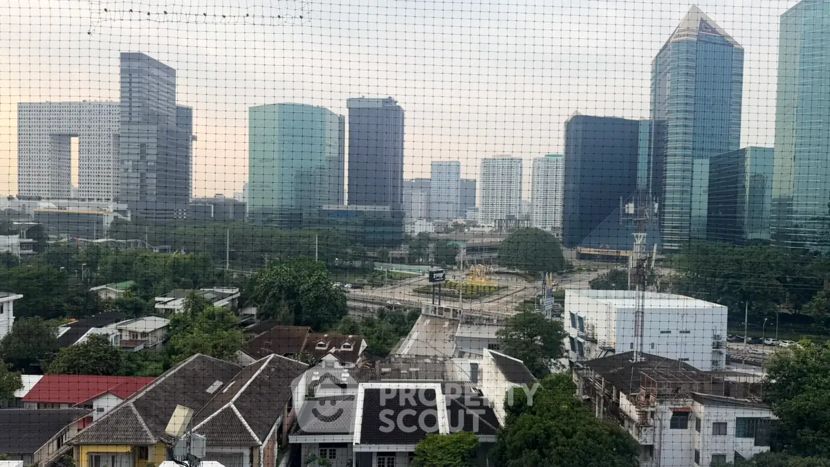 Stunning cityscape view with modern skyscrapers and residential rooftops, perfect for urban living enthusiasts.