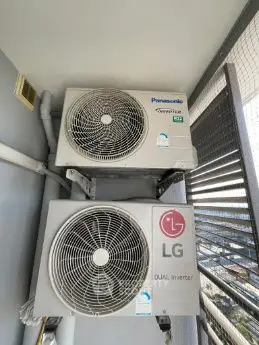 Outdoor balcony with dual inverter air conditioning units installed for efficient cooling.