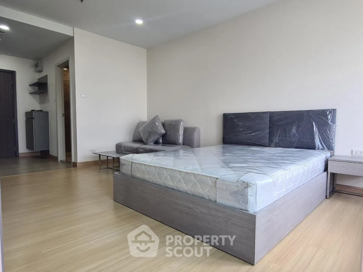 Modern bedroom with wooden flooring and stylish furniture in a spacious apartment
