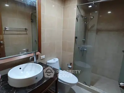 Modern bathroom with glass shower and elegant fixtures in a stylish real estate property.