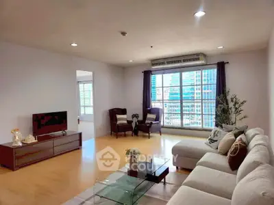 Spacious living room with modern decor and city view, perfect for urban living.