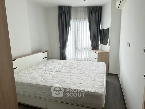 Modern bedroom with large window and minimalist furniture design.