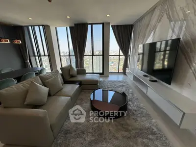 Luxurious modern living room with panoramic city view and elegant furnishings.