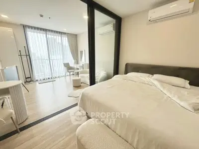 Modern bedroom with open layout and balcony view in a stylish apartment