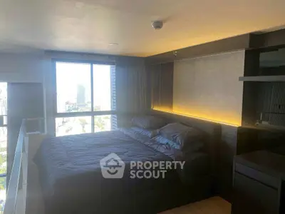 Modern bedroom with large window offering city view and sleek design.