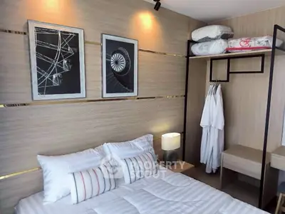 Modern bedroom with stylish decor and cozy bedding in a contemporary apartment.