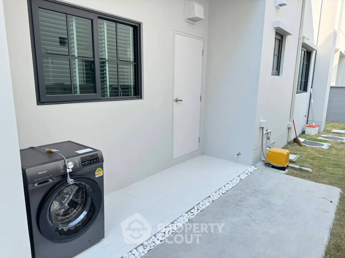 Modern exterior with washing machine and sleek design