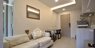 Modern living room with cozy sofa and compact dining area in stylish apartment.