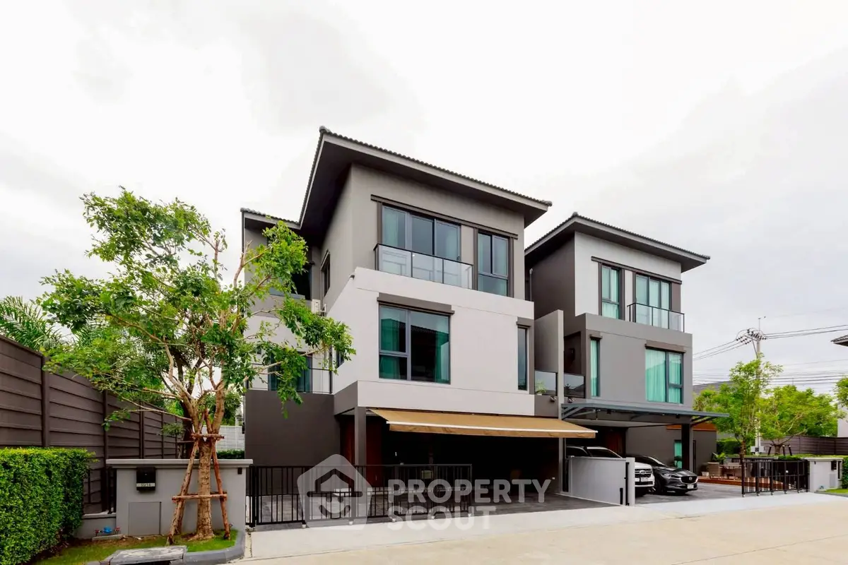 Modern three-story house with sleek design and spacious driveway