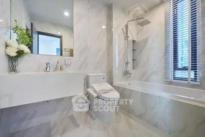 Luxurious modern bathroom with marble tiles and elegant fixtures