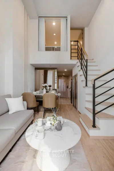 Modern duplex living room with stylish furniture and elegant staircase